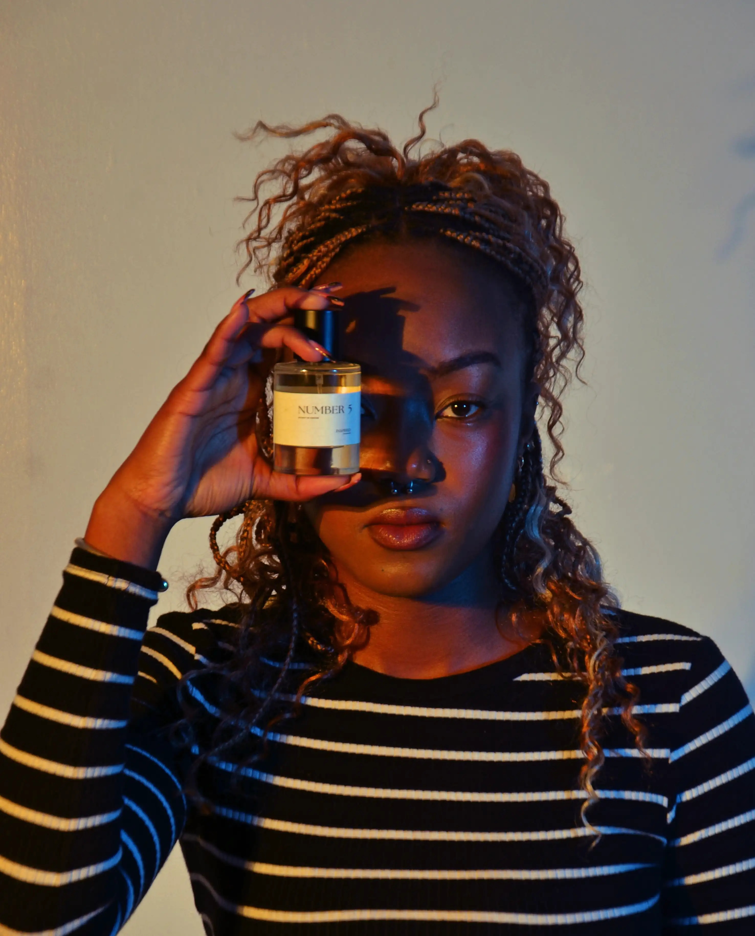 Woman holding Inspired Number 5 fragrance